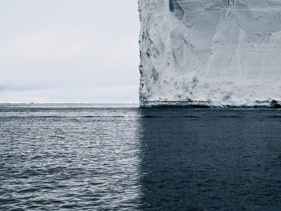 Vast iceberg and its shadow split the image into a quadrant